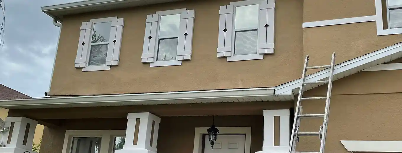 Repainted stucco around upper-story windows, Central Florida example