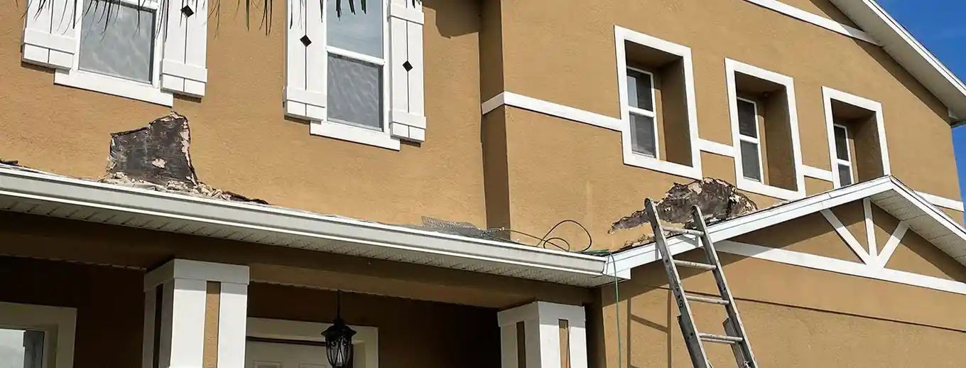 Visible stucco failure and cracking where the wall meets the eave, Central Florida example