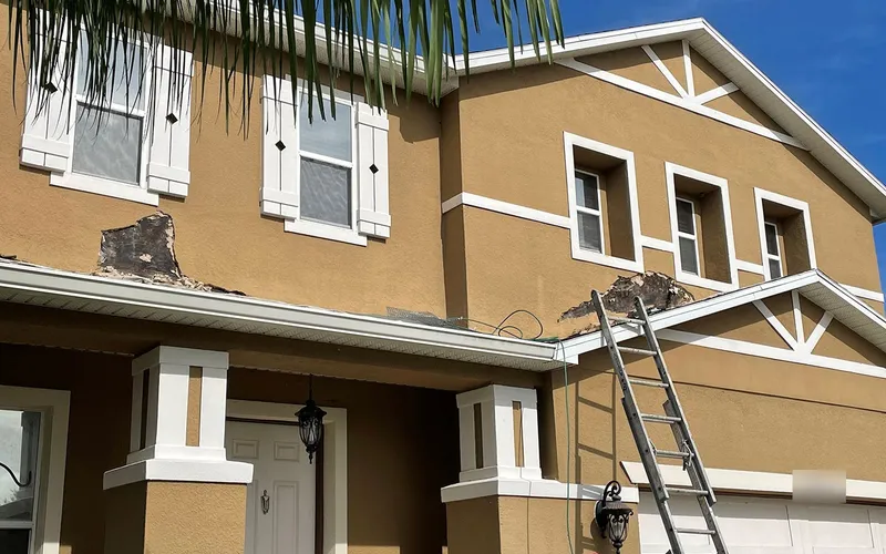 Visible stucco failure and cracking where the wall meets the eave, Central Florida example