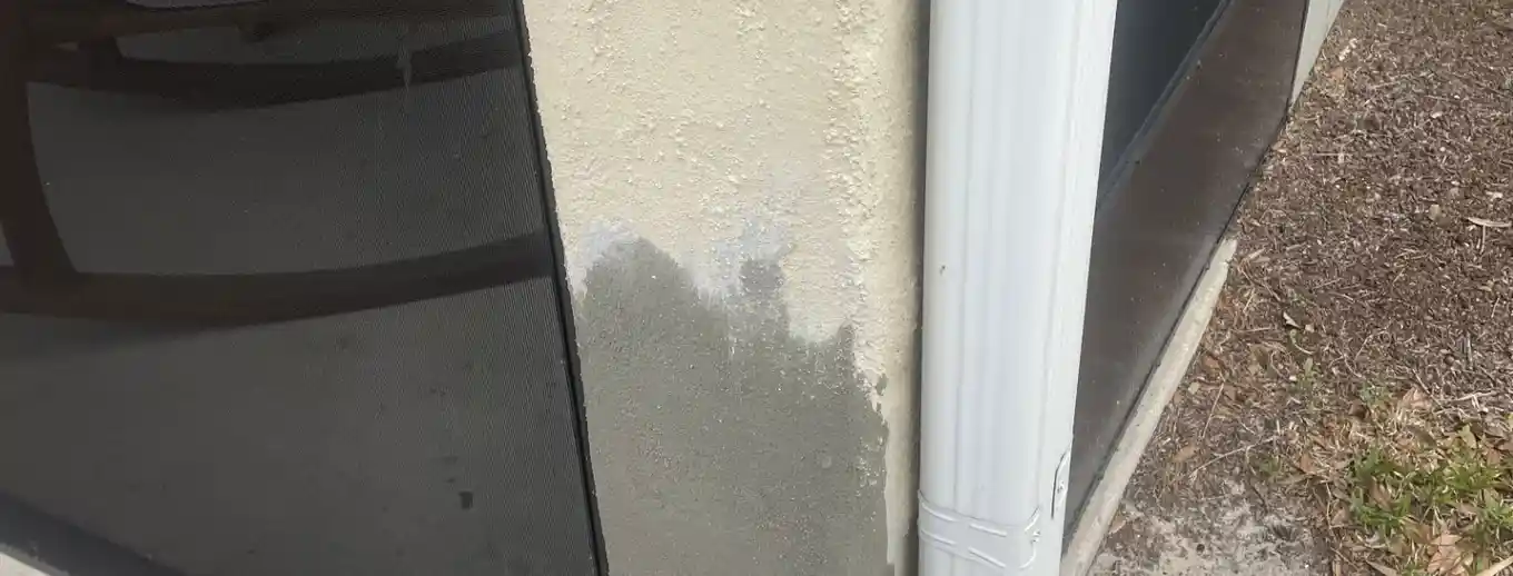 A stucco column base repaired and primed, Central Florida example