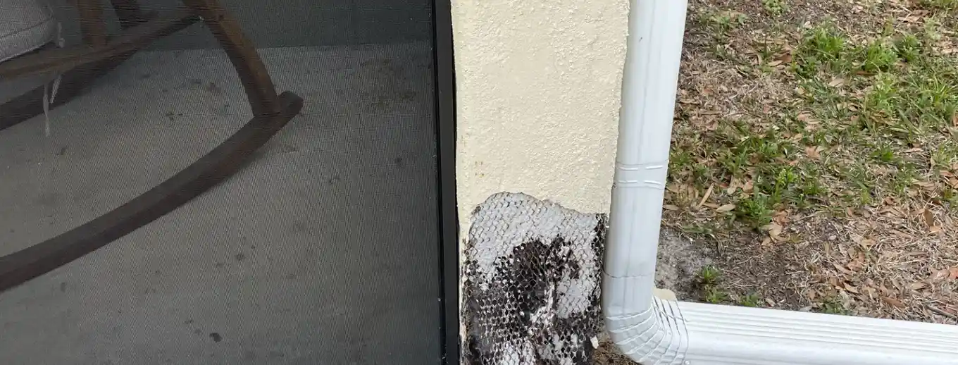 Stucco cut back to bare lath at a wall corner, Central Florida example