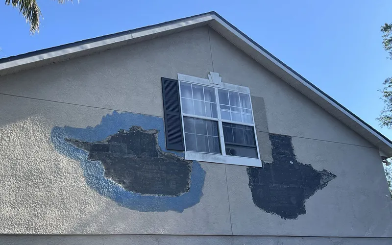 The wall opened up, moisture barrier exposed beneath the removed stucco, Central Florida example