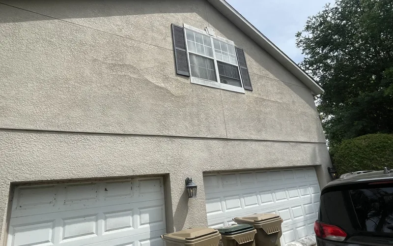 Discolored, uneven stucco spreading around an upper window, Central Florida example